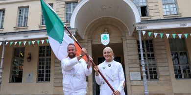 Shane Lowry agus Sarah Lavin le bratach na hÉireann a iompar anocht i bPáras