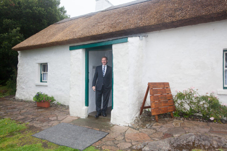 An Taoiseach standing at the doorway of Padraig Pearse's cottage in Ros Muc, Connemara, Monday. Pic: Seán Ó Mainnín.
